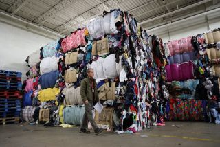 Piles of wasted clothing. Textile waste.